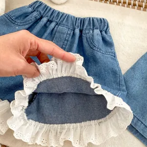 Girls denim shorts with elastic waist and white lace trim in medium blue wash