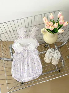 Detail of infant floral romper with rabbit ear collar and lace bow baby shoes in a cart