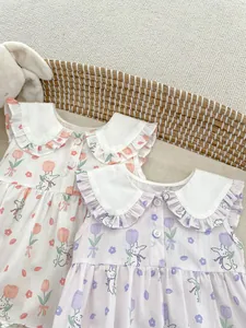 Detail of baby sleeveless rompers featuring bunny prints and white ruffle collars