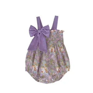 Infant girl summer purple floral romper with large bow accent and elastic bodice