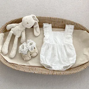 Baby white floral lace romper set with matching shoes and plush bunny in a basket