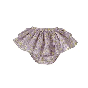 Infant floral bloomer shorts with double ruffled layers and purple flower pattern