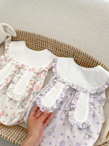 Detail of baby rompers with rabbit ears and floral pattern in a woven basket
