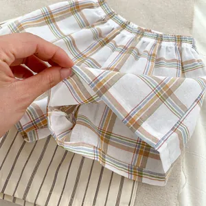 Kids plaid cotton shorts with elastic waistband showing breathable and thin fabric texture
