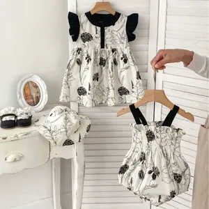 Infant floral summer dress and romper set with sun hat in monochrome garden style