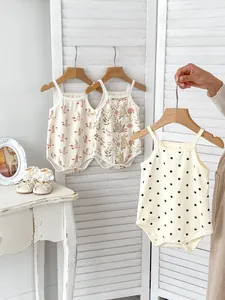 Detail of baby sleeveless rompers with cute rabbit and polka dot prints on soft cotton
