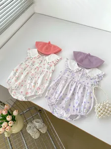Flat lay of baby sleeveless rompers with rabbit tulip patterns and matching beret hats