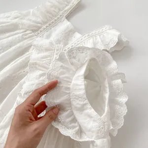 White cotton baby bodysuit featuring vintage floral embroidery and ruffle sleeves design