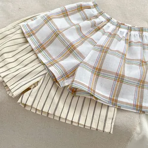 Close-up of baby shorts in colorful plaid and striped breathable cotton linen fabric