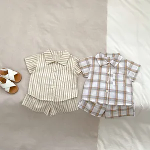 Detailed flat lay of toddler summer sets featuring striped and plaid cotton linen shirts