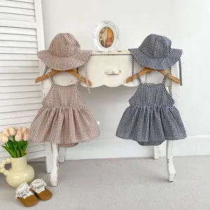 Infant summer gingham romper set with matching sun hat and ruffle details on hanger