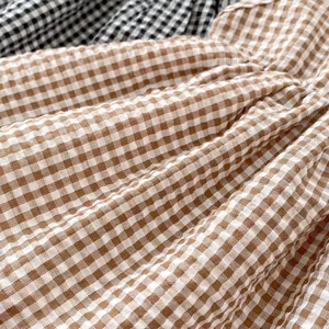 Summer plaid baby girl romper dress in brown and black checkered cotton fabric