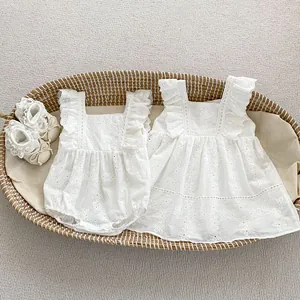 Detail view of baby cotton romper and dress set with hollow floral lace embroidery