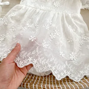 White floral embroidered baby girl romper dress with scalloped edges and breathable fabric