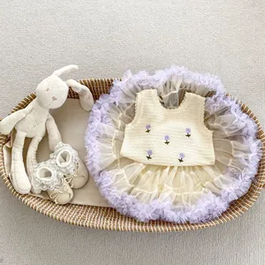 Detailed flat lay of baby girl knit vest with floral embroidery and tulle skirt set