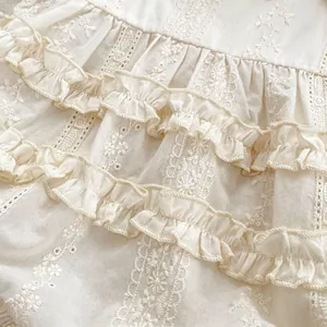 Off-white baby girl bodysuit featuring 3D floral embroidery and lace ruffles