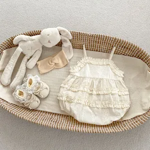Detail of baby girl lace bodysuit set with floral embroidery and bohemian frills