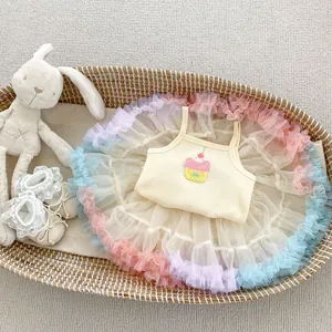 Baby girl summer set with yellow strap top and rainbow mesh tutu skirt in a woven basket