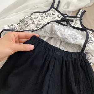 Detail of elastic waistband on black baby shorts with a focus on fabric texture