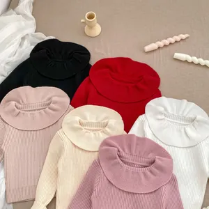 Detail of ruffled high-neck sweaters in six colors including red and white knit textures