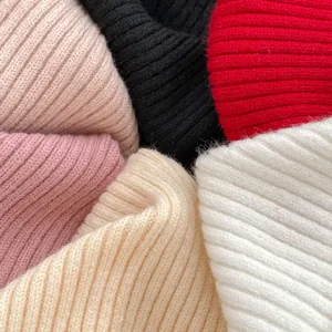 Girl's sweater with ribbed knit texture shown in pink, yellow, black and white colors