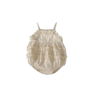Infant lace ruffle bodysuit in cream cotton with floral embroidery and snap closure