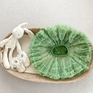 Detail of soft green tulle tutu skirt with layered ruffles in a cozy nursery setting