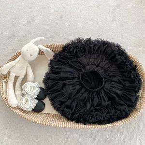Close-up of black mesh tutu skirt with layered tulle fabric and infant leather shoes