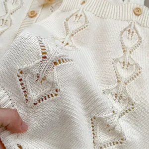 Infant cream knit bodysuit and cardigan set with hollow diamond patterns and wood buttons