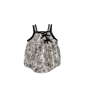 Baby girl summer floral cotton romper with bow details and black botanical print