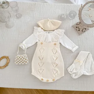 Detailed flat lay of knit romper set with lace top, beret, socks, and pearl bag