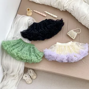Detailed close-up of fluffy multi-colored mesh tutu skirts for girls on a cozy display