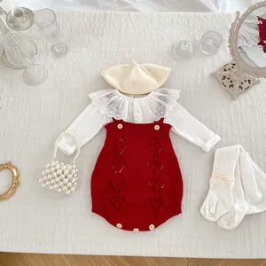 Flat lay of baby girl knit romper set with lace collar shirt, beret, and socks