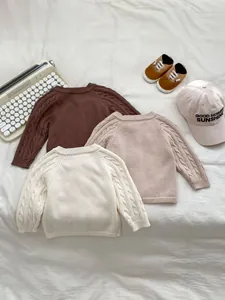 Detailed cable knit texture on toddler retro crewneck sweaters in earthy tones