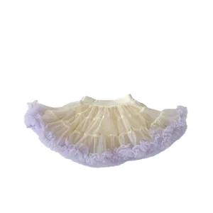 Puffy cream tutu skirt for girls with light purple ruffled lace hem on a white background