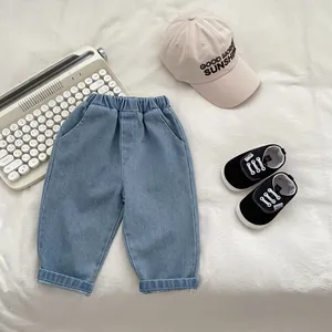 Detail of light blue kids denim pants with elastic waist and casual cuffed leg design