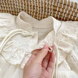 Newborn baby girl romper with floral embroidery, traditional knots and mesh skirt