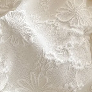 Close-up of cream floral jacquard fabric for baby girl new Chinese style romper
