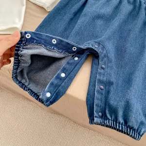 Detail of snap button crotch on baby denim romper for easy diaper changes