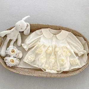 Close-up of baby romper with floral petal skirt and lace trim in a woven basket