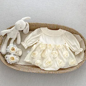 Detail of baby girl cream bodysuit dress with 3D floral petals and lace shoes