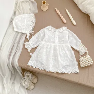 Detail view of 4-piece white lace baby bodysuit set with bonnet, shoes and mini handbag