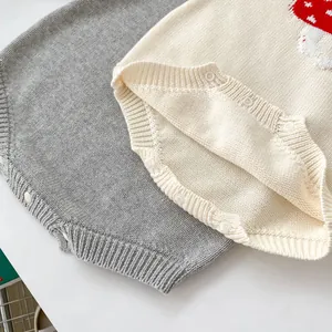 Close-up of knit baby romper fabric texture with mushroom pattern and resin buttons