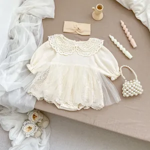 Detail of baby girl lace romper set with matching headband and shoes on flat lay
