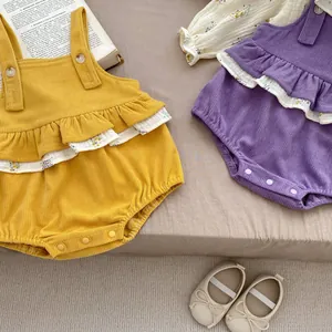 Detail of baby floral ruffles and corduroy texture on yellow and purple bodysuits
