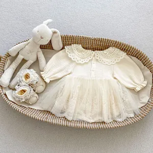 Detail of baby girl lace romper with ruffled collar and matching soft mesh shoes