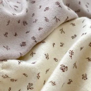 Tissu en maille de coton à fleurs pour grenouillères bébé en rose clair et blanc cassé