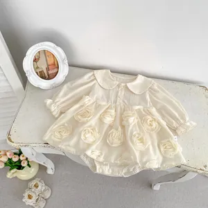 Detail of 3D rose appliques and frill cuffs on cream long-sleeve baby girl dress