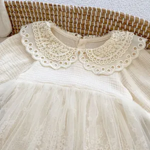 Close-up of baby girl lace bodysuit with delicate tulle skirt and vintage collar detail