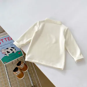 Detailed view of cream baby thermal shirt with soft texture and mock neck collar design